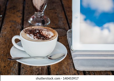 Coffee cup and tablet