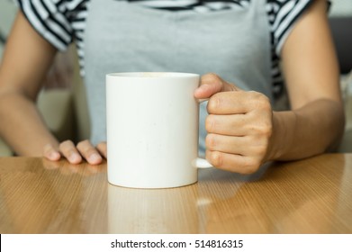 Coffee cup in woman hand.