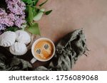 Coffee cup, zephyr and spring flowers. Romantic breakfast background. Top view.