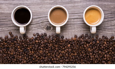 Coffee Cups With Coffee Disposed In Horizontal Row From Different Taste On Wooden Background