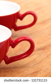  coffee cups with heart shape elements on wooden table on valentines day background