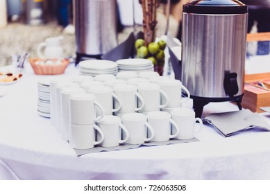 Coffee, Cups On Catering Table At Conference Or Wedding Banquet. Group Of Empty White Ceramic Cups For Coffee Or Tea In Outside Buffet At The Business Meeting Event Or Hotel.