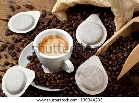 Coffee cups with pods on rustic table