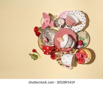 Coffee cups and saucers, colorful flowers, creative mess composition against warm sandy brown background.  - Powered by Shutterstock