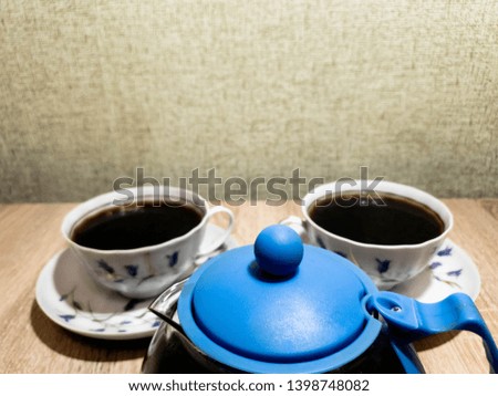 Coffee in cups. Coffee in a teapot and cups