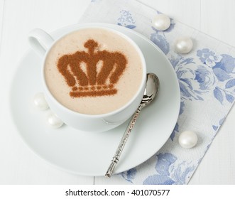 Coffee Decorated With Queen Crown. British Symbol Paper Napkin. Sweets. White Wooden Table.