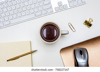 Coffee Desk Keyboard Mouse Notepad Pen Paper Clips Mouse Pad Close Up White Desk Clean Rose Gold From Above Overhead Flat