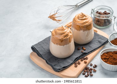Coffee dessert, whipped foam and milk on a gray background. A traditional Korean drink. Side view, copy space.
