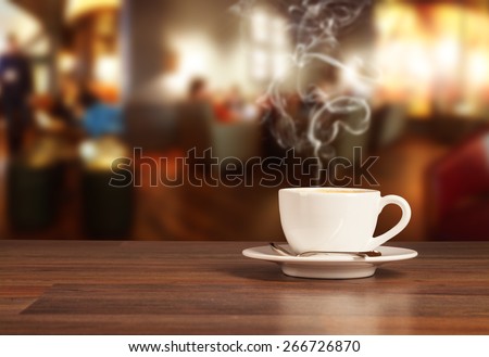 Coffee drink on wooden table with blur cafeteria as background
