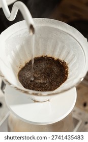 Coffee drips through a filter with coffee grounds