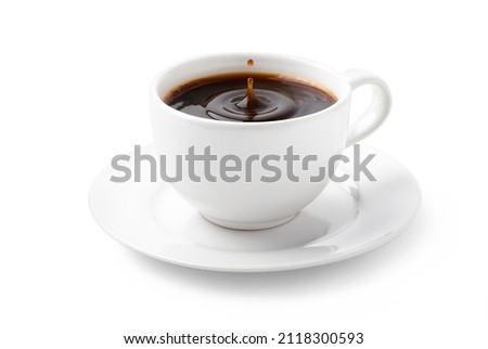 Coffee drops in white cup isolated on white background. Clipping path.