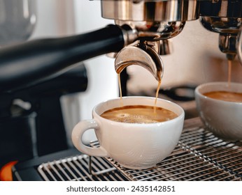 Coffee extraction from the coffee machine with a portafilter pouring coffee into a cup,Espresso poruing from coffee machine  - Powered by Shutterstock