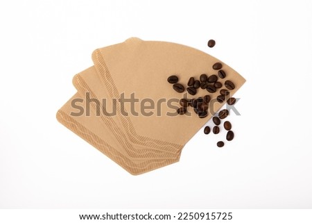 Coffee filter with beans and ground coffee isolated on white background.