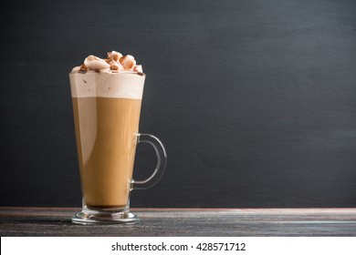 Coffee in glass on the rustic wooden background
