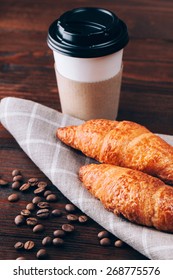 Coffee To Go With Croissants Or Baking Lying On Wooden Table