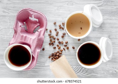 Coffee To Go. Coffee Cups With Cover And Coffee Beans On Wooden Table Backound Top View