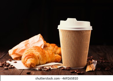 Coffee To Go In A Paper Cup With Croissants On Wooden Table, Selective Focus