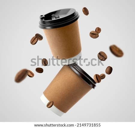 Coffee to go. Paper cups and roasted beans flying on light background