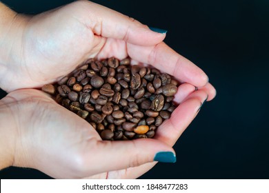Coffee grains in woman hand. - Shutterstock ID 1848477283