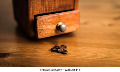 Coffee Grinder With Coffee Beans In The Foreground. Still Life Picture With Small Aperture.