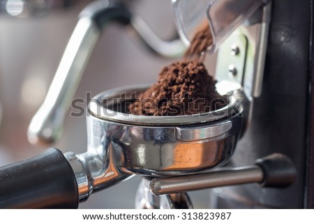 coffee grinder grinding freshly roasted  make beans into a powder