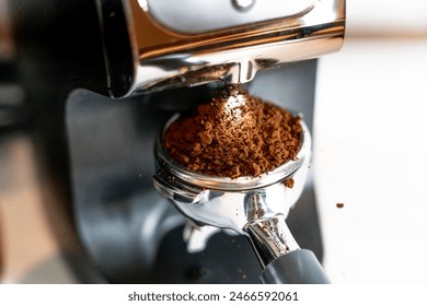 Coffee grinder with portafilter and ground coffee black and silver minimal aesthetic speciality coffee grinding coffee shop barista - Powered by Shutterstock