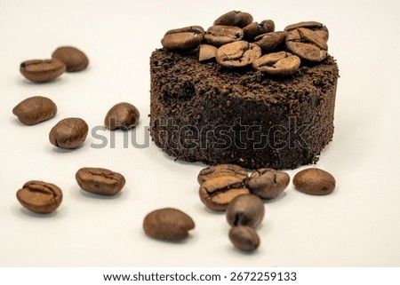 Coffee grounds pressed with coffee beans