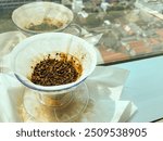 coffee grounds from v60 filter with building and housing scene in the background