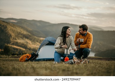 Coffee and happy couple camping, laugh and bond together for holiday, love connection and morning tea - Powered by Shutterstock