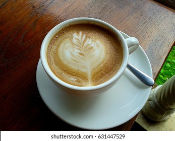 The Coffee have leaf pattern from milk in White cup