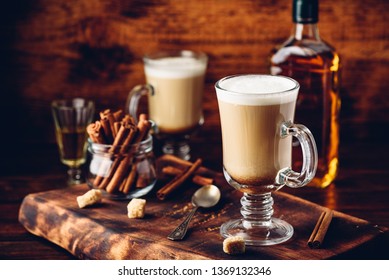 Coffee with Irish whiskey and whipped cream in glass on rustic wooden surface - Shutterstock ID 1369132346