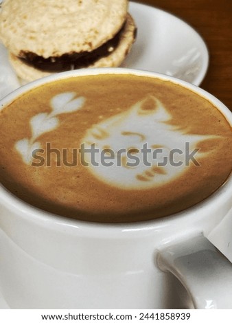 Coffee, latte art, cat drawing in cup of coffee. Tasty drinks, cafe beverages, cute animal picture. Food art, cookie. Sweets, caffein, decaf. Barista art