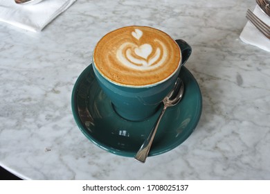 Coffee With Latte Art On The Marbel Table.