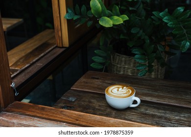 Coffee Latte Art On Wood Table Background