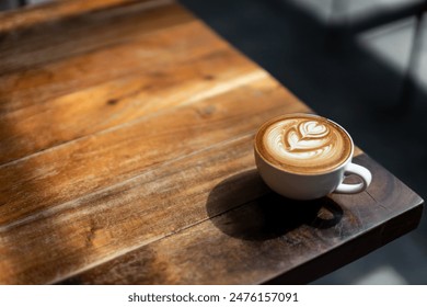 coffee latte art on wood table in cafe nature light  - Powered by Shutterstock