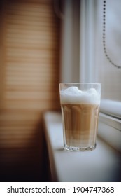 Coffee Latte In A Tall Glass With Cream Poured