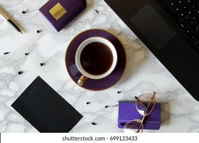 coffee, leptop and empty notepad with pencil on marble background. top view