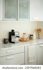 Coffee machine, jars and cups on kitchen counter