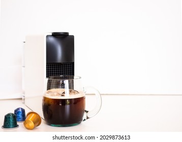 Coffee machine makes americano black coffee from coffee capsule.