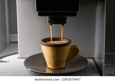 Coffee machine pouring espresso into edible biscuit cup - Powered by Shutterstock