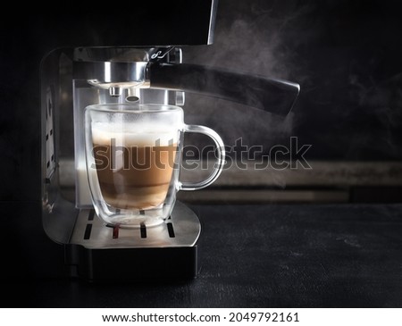 Coffee machine with steam in the process of making coffee.The Concept Of A Coffee-Making Service.