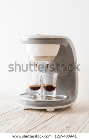 coffee maker machine making coffee on wood background