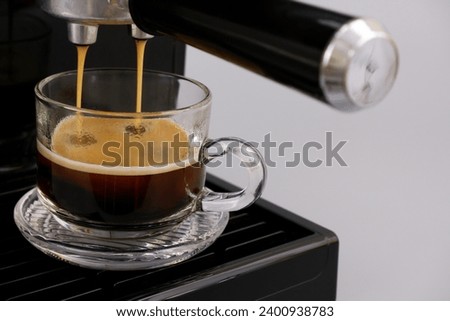 Coffee maker making espresso coffee close-up.