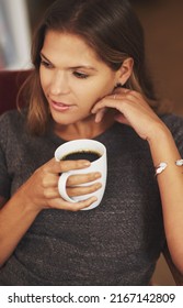 Coffee Makes Me Time Extra Special. Shot Of A Young Woman Enjoying A Cup Of Coffee At Home.