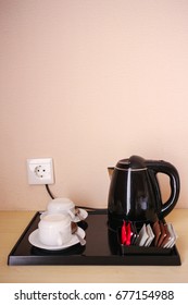 Coffee Making Set In A Hotel Room With Electric Kettle, Clean Cup And Teaspoon, Instant Coffee, Brown Sugar And Creamer  On A Black Tray