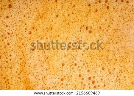Coffee milk foam. Background texture of cappuccino, closeup. Macro.