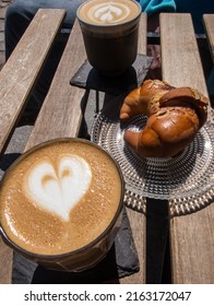 Coffee With Milk In A Glass Cup, With A Heart Made Of Foam.