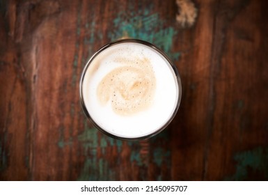 Coffee with milk on rustic wooden background. Soft focus. Top view.  Close up. Copy space.	                               