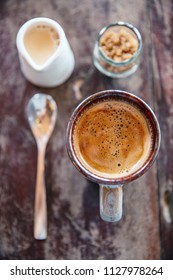 Coffee Mug With Milk Creamer Brown Sugar Jar And Spoon On Wooden Table Top View In Morning