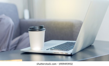 A Coffee Mug On A Businessman's Laptop For Drowsy Drinking